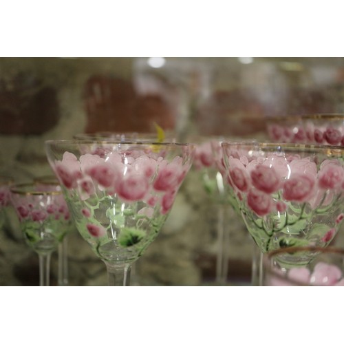 56 - An early 20th century Continental glass table service with enamelled pink cabbage rose decoration an... 