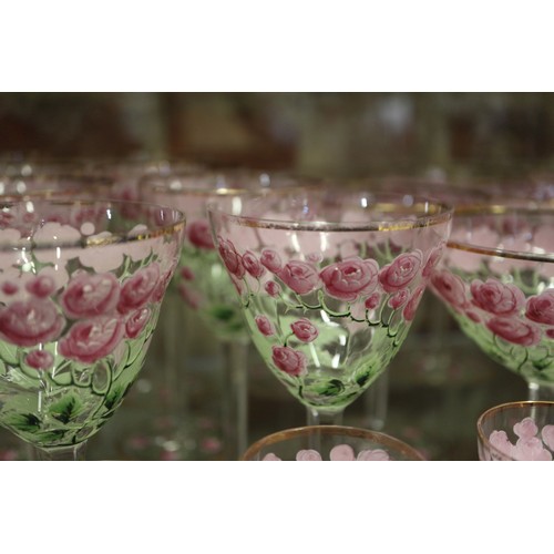 56 - An early 20th century Continental glass table service with enamelled pink cabbage rose decoration an... 