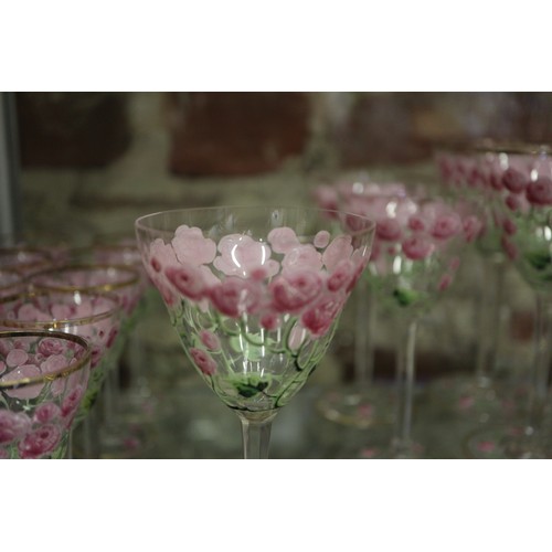 56 - An early 20th century Continental glass table service with enamelled pink cabbage rose decoration an... 