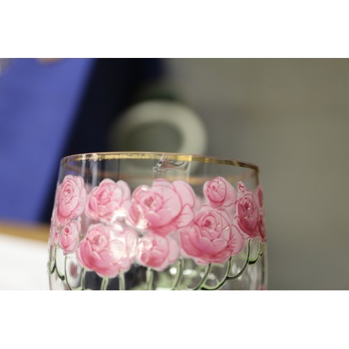 56 - An early 20th century Continental glass table service with enamelled pink cabbage rose decoration an... 