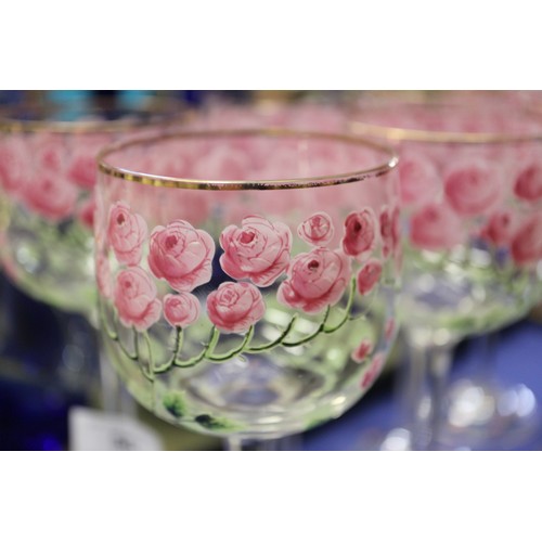 56 - An early 20th century Continental glass table service with enamelled pink cabbage rose decoration an... 