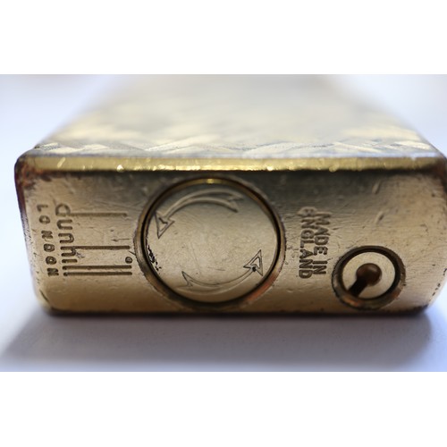 210 - A Dunhill gold plated cigarette lighter with Florentine design, in associated box