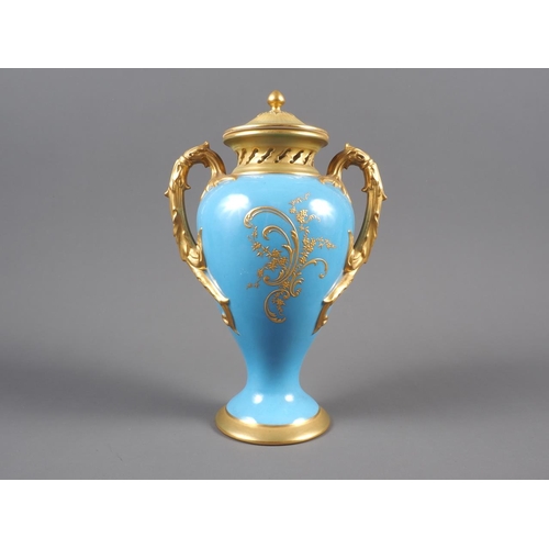 34 - An early 20th century Royal Worcester two-handle vase and cover with fruit decorated panel on a blue... 