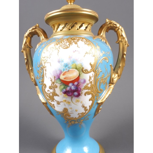 34 - An early 20th century Royal Worcester two-handle vase and cover with fruit decorated panel on a blue... 