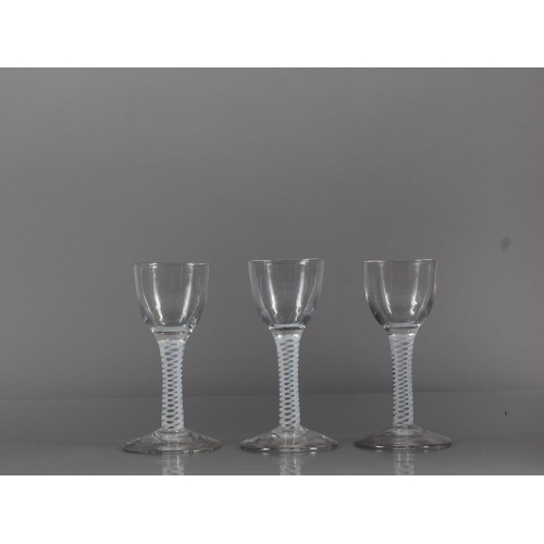 76 - Three cordial glasses with cotton twist stems, 4.6