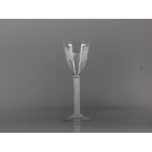 82 - A wine glass of Georgian design, with vine engraved bowl and cotton twist stem, 7 1/2