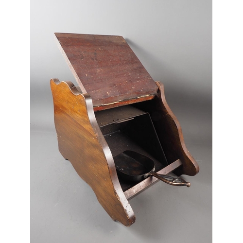 177 - An Edwardian walnut coal scuttle with brass mounts and anodised scoop