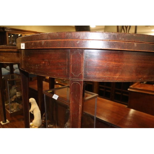 444 - A Georgian mahogany and line inlaid fold-over top semicircular card table, on square taper supports,... 