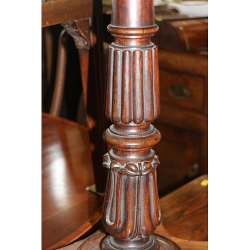 472 - An early 19th century rosewood fold-over top work table with faux leather interior, on turned column... 