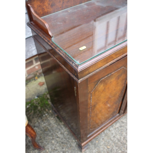 545 - A figured walnut ledge back side cupboard with felt lined shelves enclosed two doors, on shaped feet... 