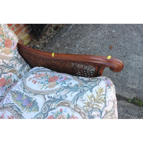 551 - A 1930s mahogany double bergere three-piece suite with feather loose seat cushions, on cabriole supp... 