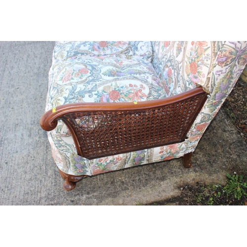 551 - A 1930s mahogany double bergere three-piece suite with feather loose seat cushions, on cabriole supp... 