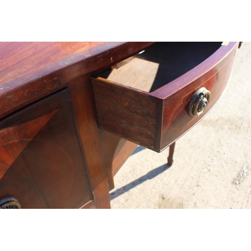 554 - An Edwardian mahogany and line inlaid serpentine front side board, fitted two cupboards and centre d... 