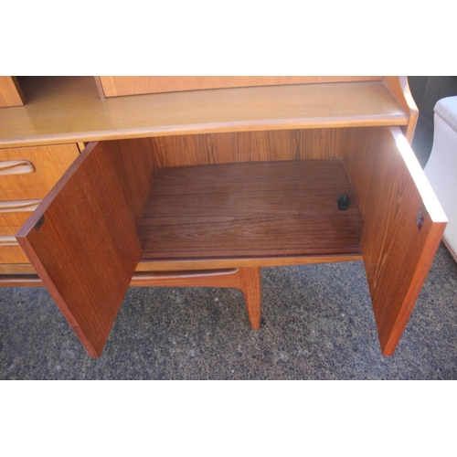 563 - A G Plan 1960 teak dining suite, comprising an oval extending dining table, six shaped vertical rail... 