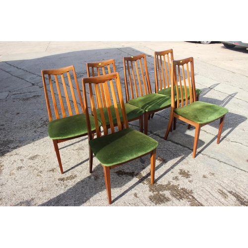 563 - A G Plan 1960 teak dining suite, comprising an oval extending dining table, six shaped vertical rail... 