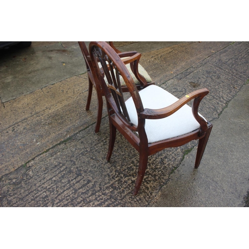 566 - A pair of Sheraton Revival oval pierced splat back elbow chairs with drop-in seats, on square taper ... 