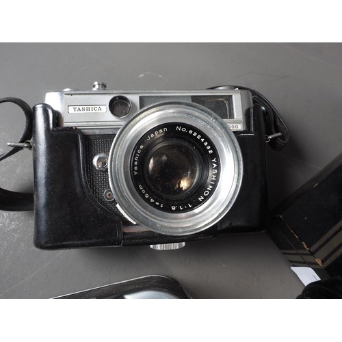 132 - An Olympus IS-1000, a Yashika Lynx 5000 and other photographic items