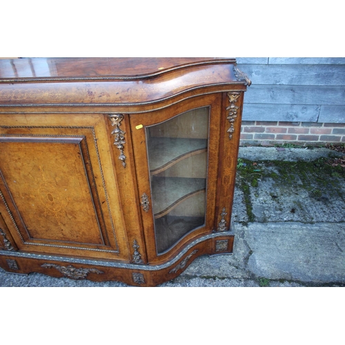 446 - A mid Victorian figured walnut and gilt bronze mounted serpentine front credenza with central door a... 