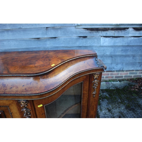 446 - A mid Victorian figured walnut and gilt bronze mounted serpentine front credenza with central door a... 