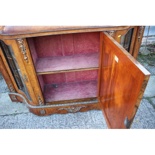 446 - A mid Victorian figured walnut and gilt bronze mounted serpentine front credenza with central door a... 