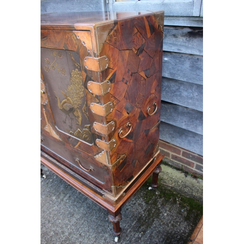 447 - A late 19th century Japanese parquetry cabinet, the interior fitted three small, three medium and tw... 