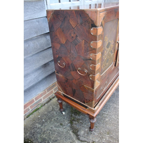 447 - A late 19th century Japanese parquetry cabinet, the interior fitted three small, three medium and tw... 