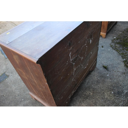 450 - An early 19th century provincial oak chest of four graduated long drawers, with brass bail handles, ... 