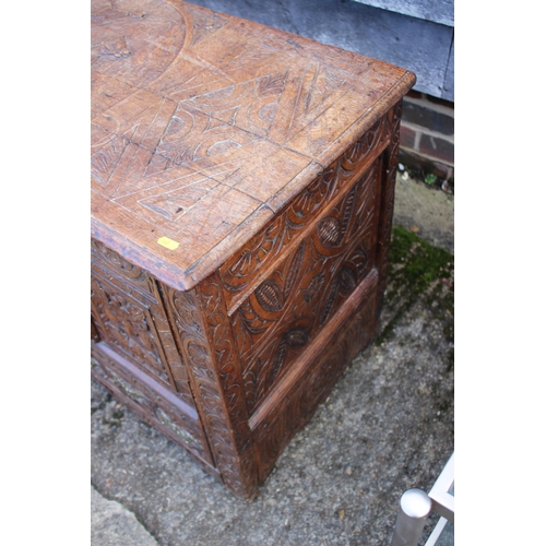 451 - An 18th century oak mule chest with later carved decoration, on stile supports, 42 1/2