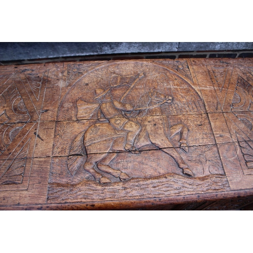 451 - An 18th century oak mule chest with later carved decoration, on stile supports, 42 1/2