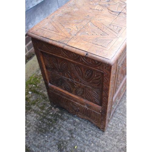 451 - An 18th century oak mule chest with later carved decoration, on stile supports, 42 1/2