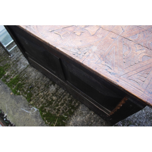 451 - An 18th century oak mule chest with later carved decoration, on stile supports, 42 1/2