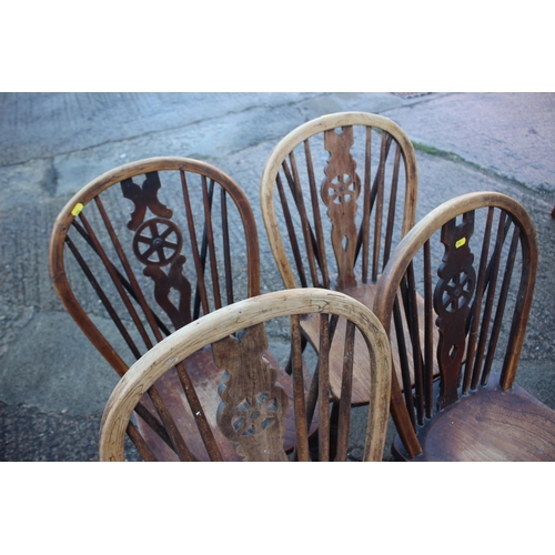 458 - A Harlequin set of four 19th century Windsor wheelback chairs with elm panel seats (3+1)