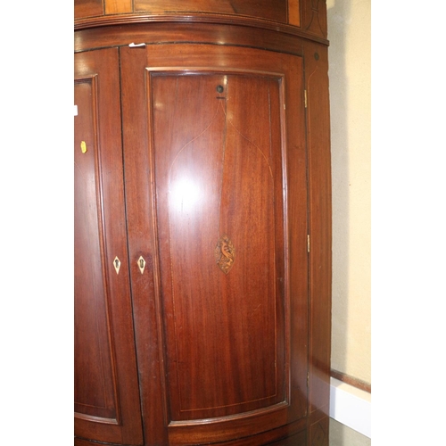 469 - A late Georgian mahogany and inlaid bowfront corner cupboard, the upper section fitted shelves and e... 