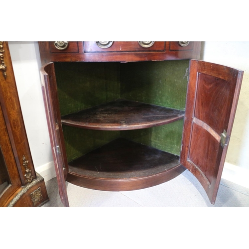 469 - A late Georgian mahogany and inlaid bowfront corner cupboard, the upper section fitted shelves and e... 