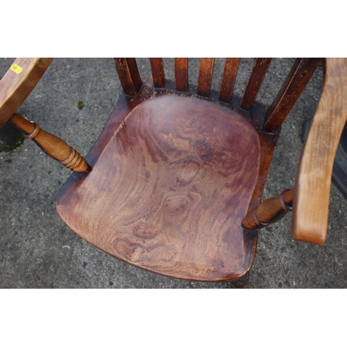 499 - A late 19th century beech and elm Windsor lath back elbow chair, on turned and stretchered supports