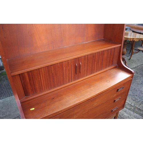 520 - A 1970s Heals teak bureau bookcase, the upper section with shelves over fitted compartment with tamb... 