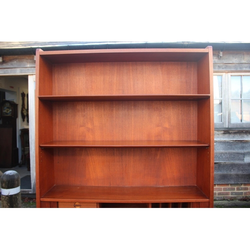 520 - A 1970s Heals teak bureau bookcase, the upper section with shelves over fitted compartment with tamb... 