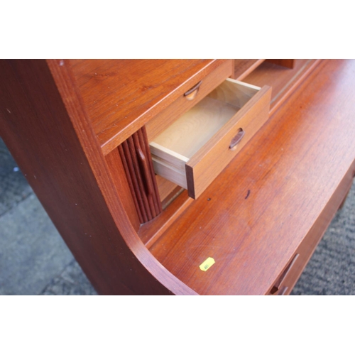 520 - A 1970s Heals teak bureau bookcase, the upper section with shelves over fitted compartment with tamb... 