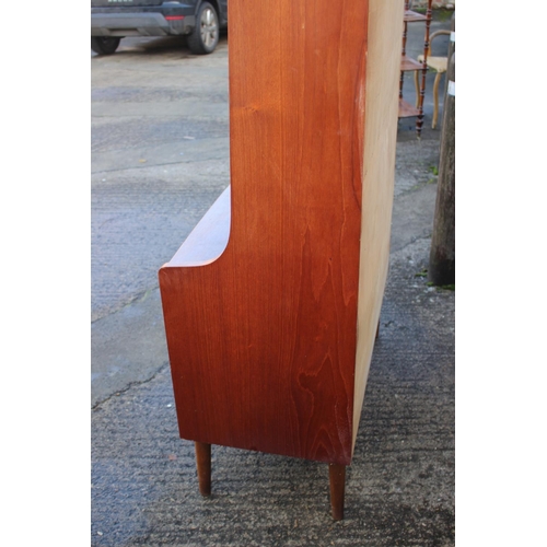 520 - A 1970s Heals teak bureau bookcase, the upper section with shelves over fitted compartment with tamb... 