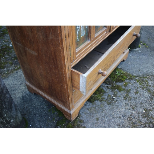 533 - A carved and painted oak linen press enclosed two doors over two drawers, on bracket feet, 33 1/2