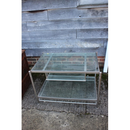 538 - A nest of three brushed steel frame and glass occasional tables, 23