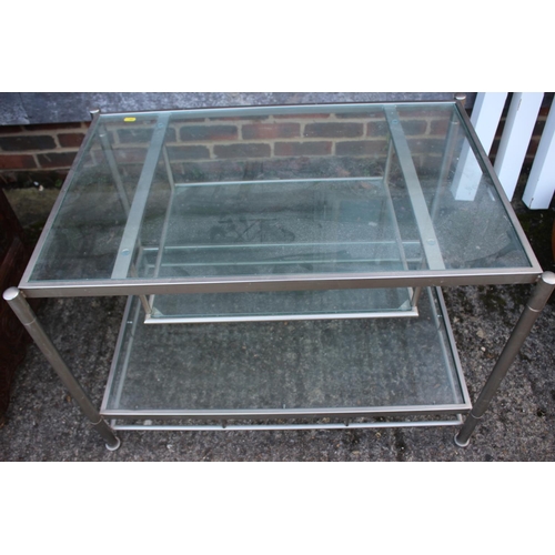 538 - A nest of three brushed steel frame and glass occasional tables, 23