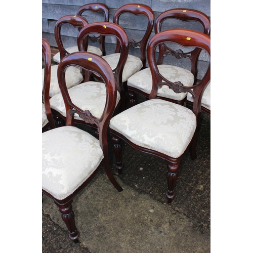 561 - A set of ten mahogany loop back dining chairs with stuffed over seats, on turned and carved supports