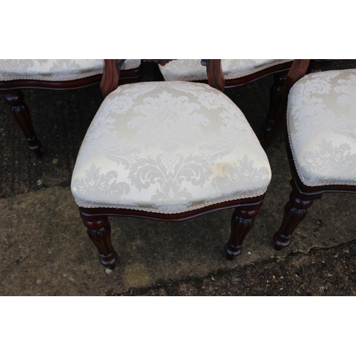 561 - A set of ten mahogany loop back dining chairs with stuffed over seats, on turned and carved supports