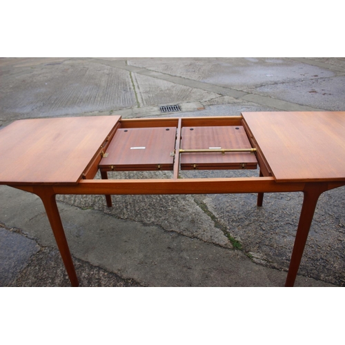 578 - An A H McIntosh & Co Ltd 1970s teak extending dining table with two extra integral leaves, 63