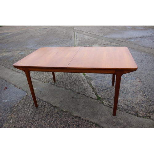 578 - An A H McIntosh & Co Ltd 1970s teak extending dining table with two extra integral leaves, 63