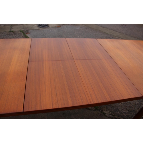 578 - An A H McIntosh & Co Ltd 1970s teak extending dining table with two extra integral leaves, 63