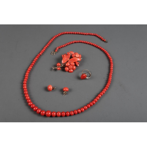 302 - A red coloured coral jewellery set comprising a floral design brooch, earrings, 9ct gold dress ring ... 