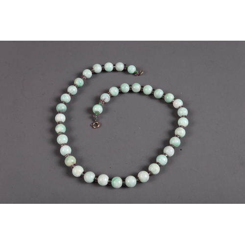 303 - A pale jade bead necklace, 17 1/2