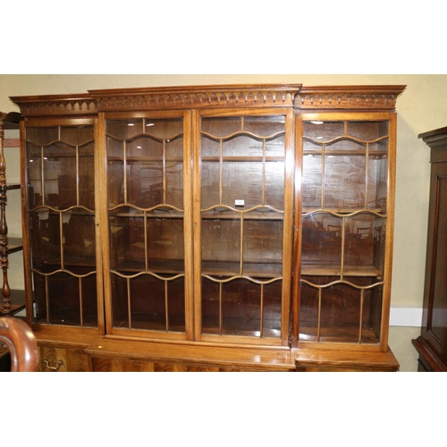 474 - A late 19th century walnut breakfront secretaire bookcase, the upper section enclosed shaped lattice... 